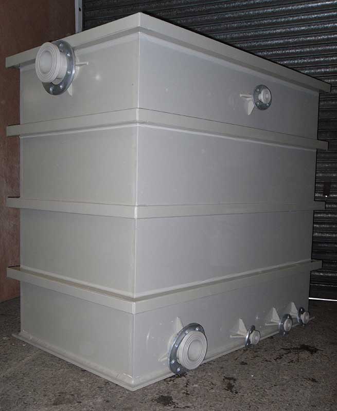 Polypropylene rectangular tank with steel reinforcement then covered over to protect the steel from chemicals